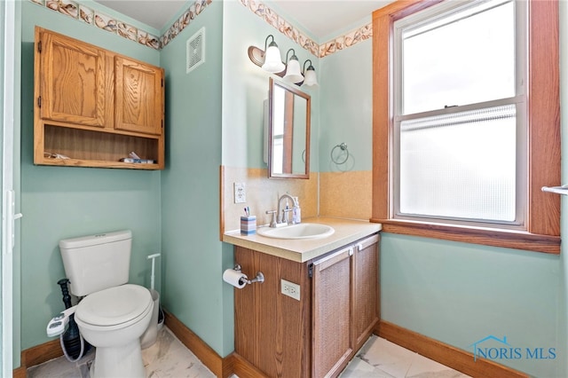 bathroom with vanity and toilet