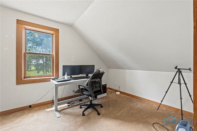 office area with carpet, lofted ceiling, and a textured ceiling