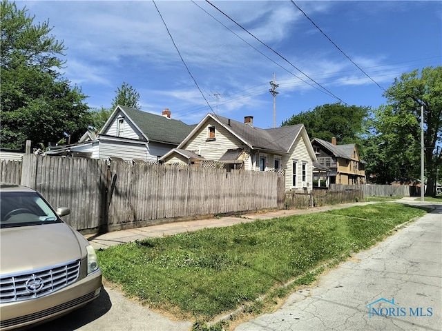 view of side of home featuring a lawn