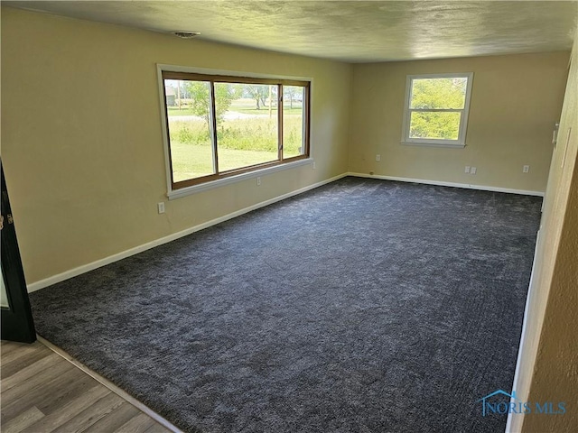 unfurnished room with dark hardwood / wood-style floors