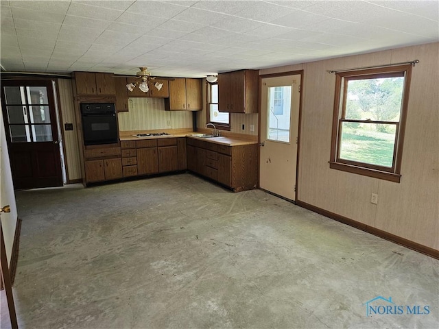 kitchen with sink, black oven, ceiling fan, and white gas stovetop