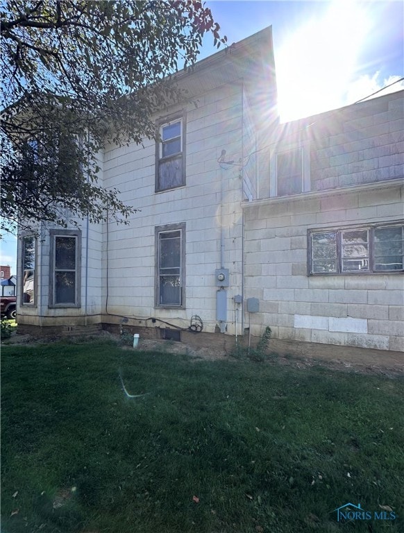 rear view of house featuring a yard