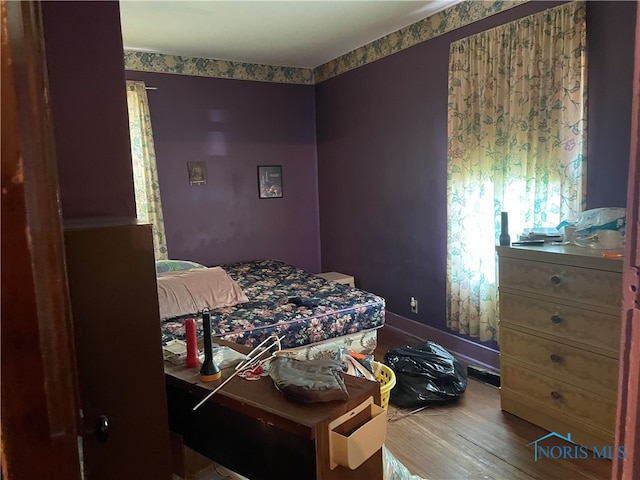 bedroom with wood-type flooring