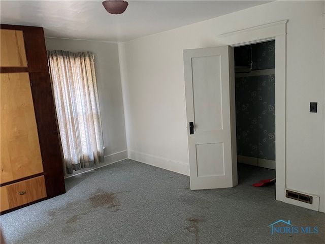 unfurnished bedroom featuring a closet and carpet flooring