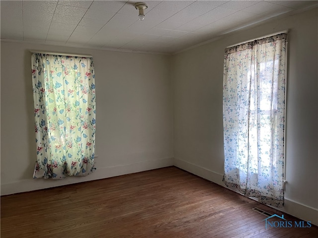 unfurnished room with hardwood / wood-style flooring