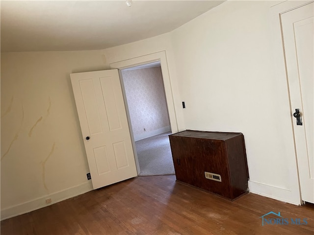 unfurnished bedroom with dark hardwood / wood-style flooring