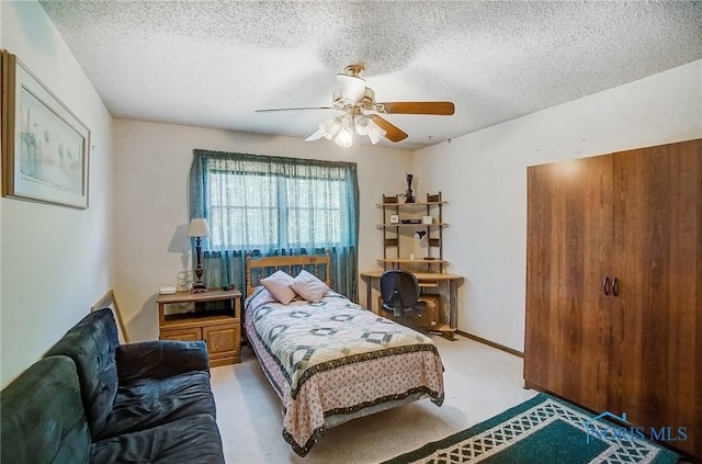 carpeted bedroom with a textured ceiling and ceiling fan