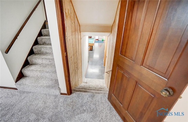 staircase featuring carpet