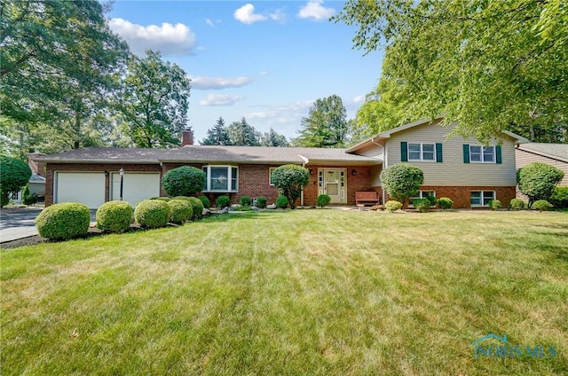 tri-level home featuring a front yard and a garage