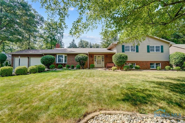 split level home featuring a garage and a front lawn