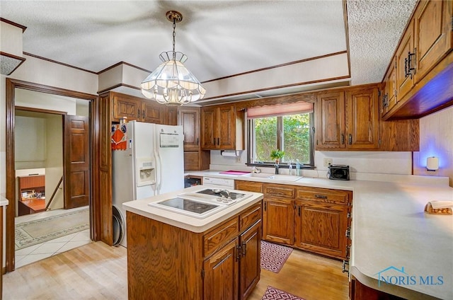 kitchen with ornamental molding, white appliances, sink, light hardwood / wood-style flooring, and hanging light fixtures