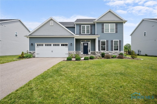 view of front of home featuring a garage and a front lawn