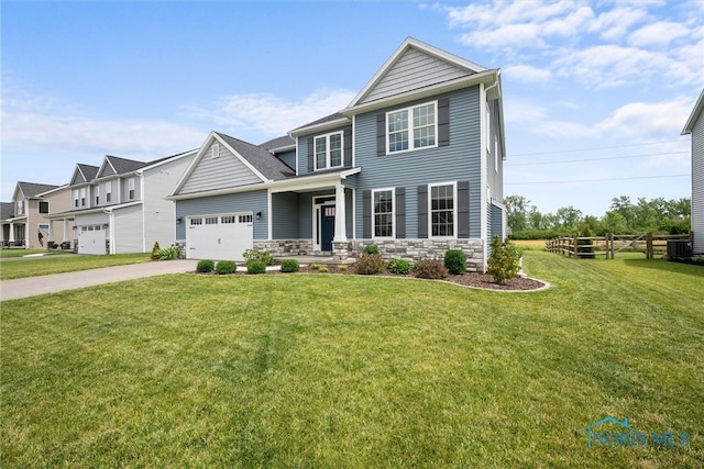 view of front of house featuring a garage and a front lawn