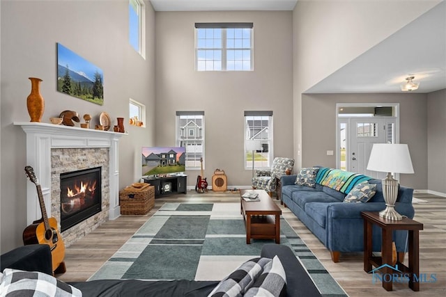 living room with hardwood / wood-style flooring and a fireplace