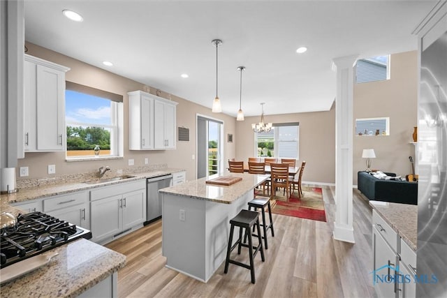 kitchen featuring white cabinetry, sink, appliances with stainless steel finishes, and a kitchen island