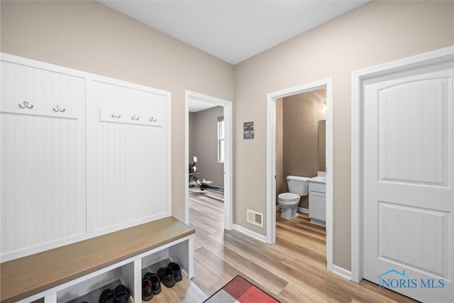 mudroom with light hardwood / wood-style flooring