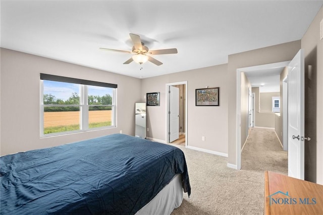 bedroom featuring light carpet and ceiling fan