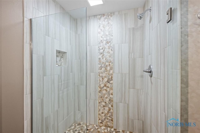 bathroom with a tile shower