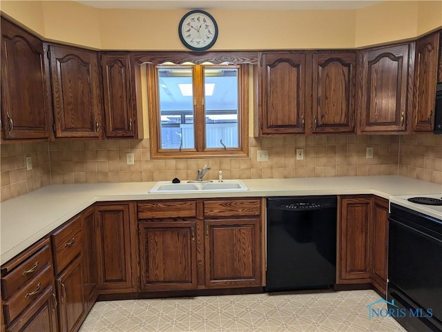 kitchen with sink, backsplash, and black appliances