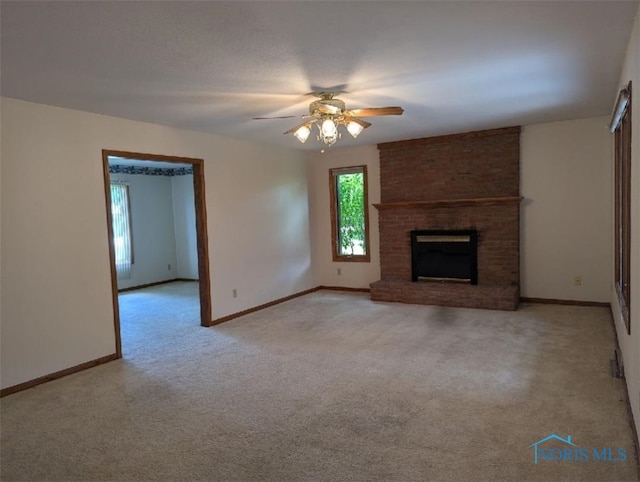 unfurnished living room with light carpet, a brick fireplace, and ceiling fan