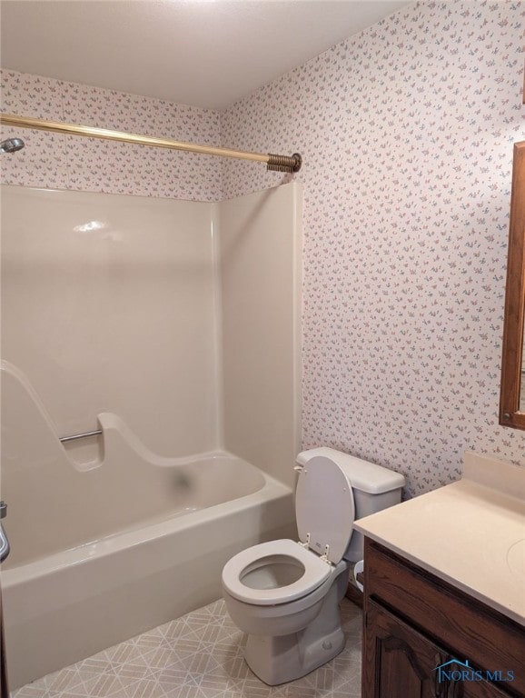 full bathroom with vanity,  shower combination, toilet, and tile patterned flooring