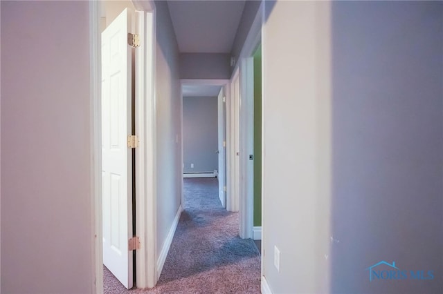 hallway with baseboard heating and carpet flooring