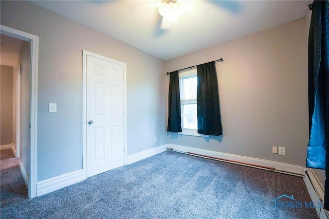 unfurnished bedroom featuring a baseboard heating unit, carpet, and ceiling fan