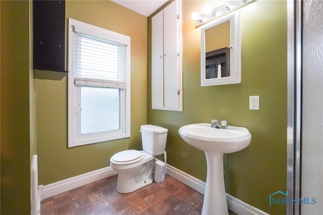 bathroom featuring toilet and tile patterned floors