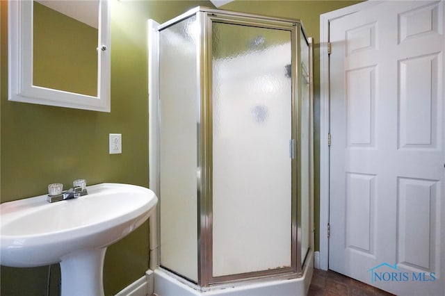 bathroom featuring walk in shower and tile patterned flooring