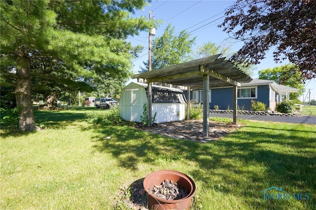 view of yard featuring a pergola and a shed