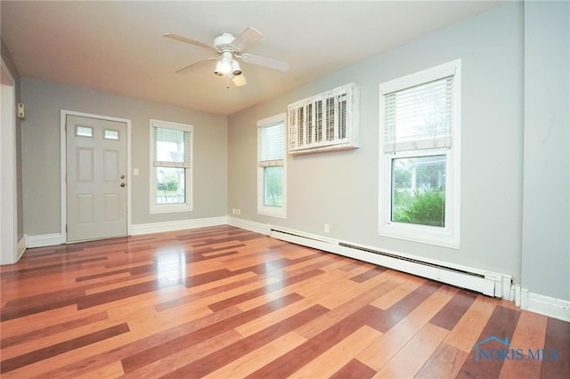 entryway with plenty of natural light, a baseboard radiator, and hardwood / wood-style flooring