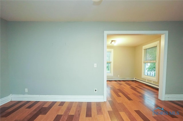 unfurnished room with hardwood / wood-style flooring