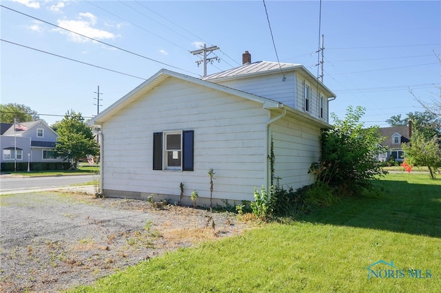 view of home's exterior with a yard