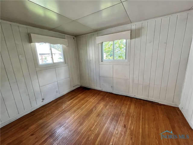 unfurnished room with hardwood / wood-style flooring