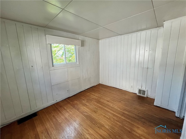 unfurnished room featuring hardwood / wood-style flooring