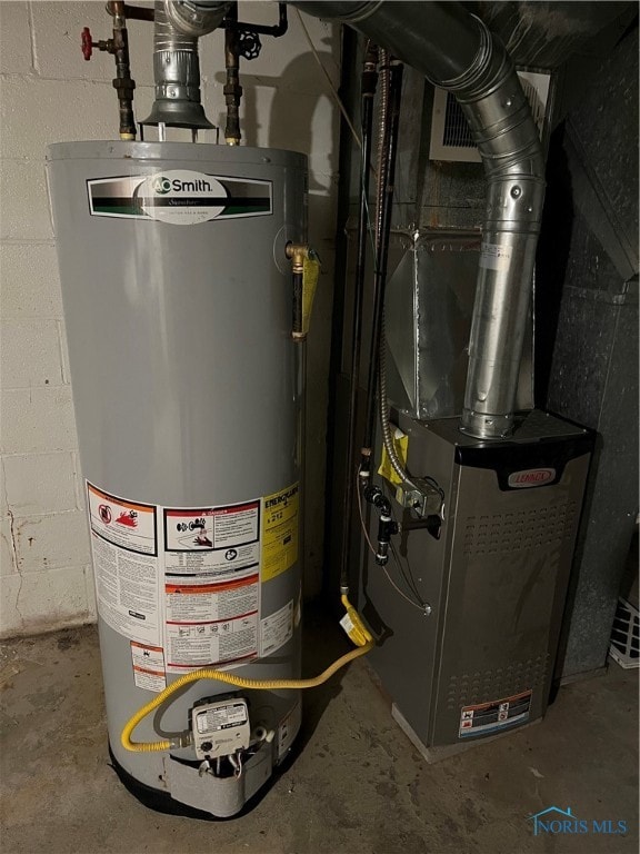 utility room with heating unit and gas water heater