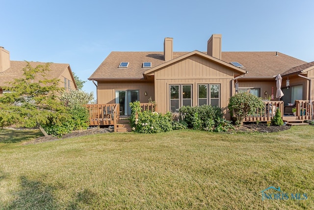 back of house featuring a yard and a wooden deck