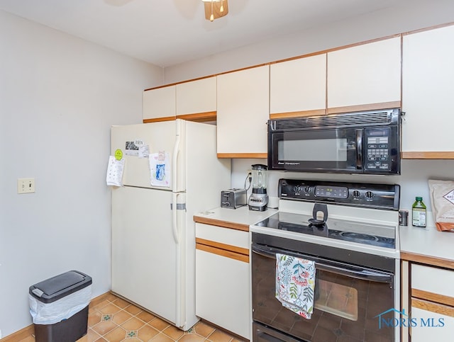 kitchen featuring light tile patterned flooring, white appliances, and white cabinets