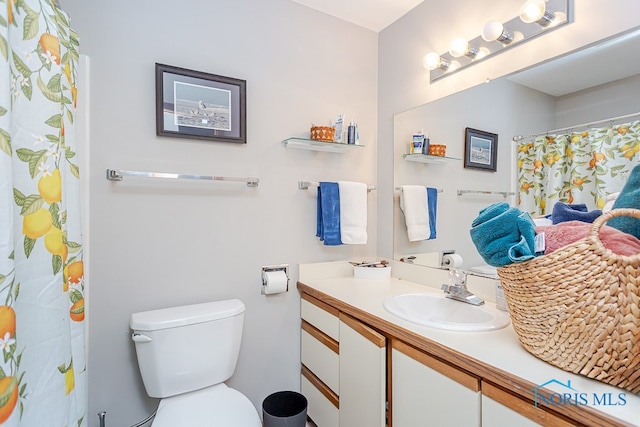 bathroom featuring toilet and vanity