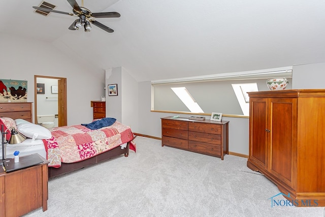 carpeted bedroom with ceiling fan and vaulted ceiling with skylight