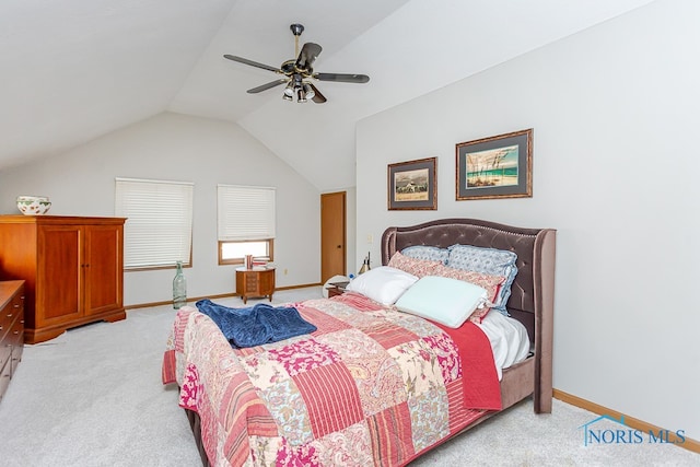 carpeted bedroom with ceiling fan and vaulted ceiling