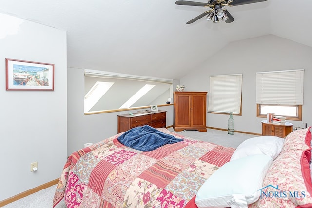 carpeted bedroom featuring ceiling fan and vaulted ceiling with skylight