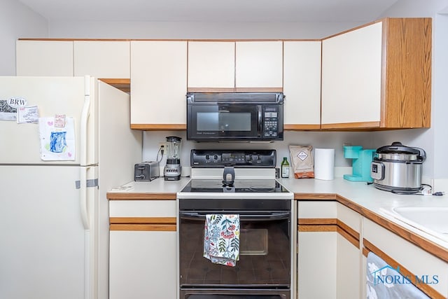 kitchen featuring white appliances and white cabinets