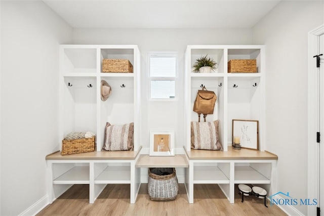 mudroom featuring wood finished floors and baseboards