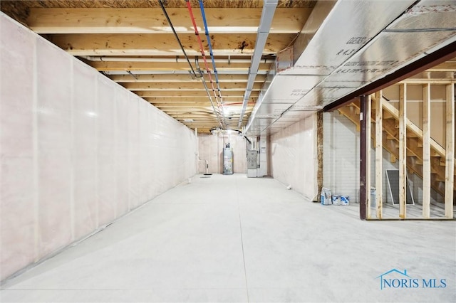 unfinished basement featuring heating unit