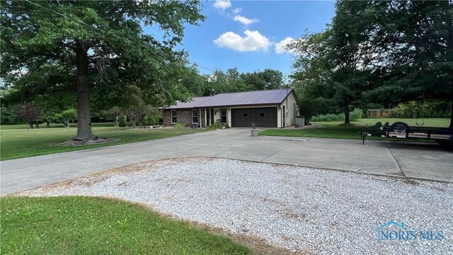 single story home with a front yard and a garage