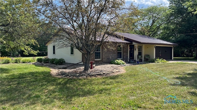 ranch-style home with a front lawn and a garage