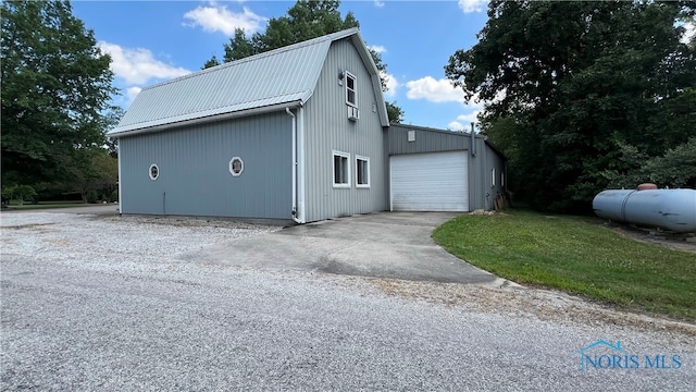 view of side of home with a garage and an outdoor structure