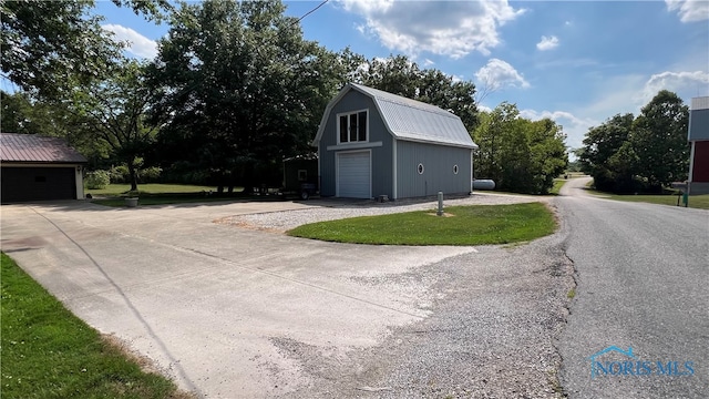 exterior space with an outbuilding and a garage