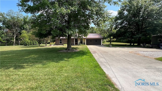 ranch-style home with a garage and a front lawn